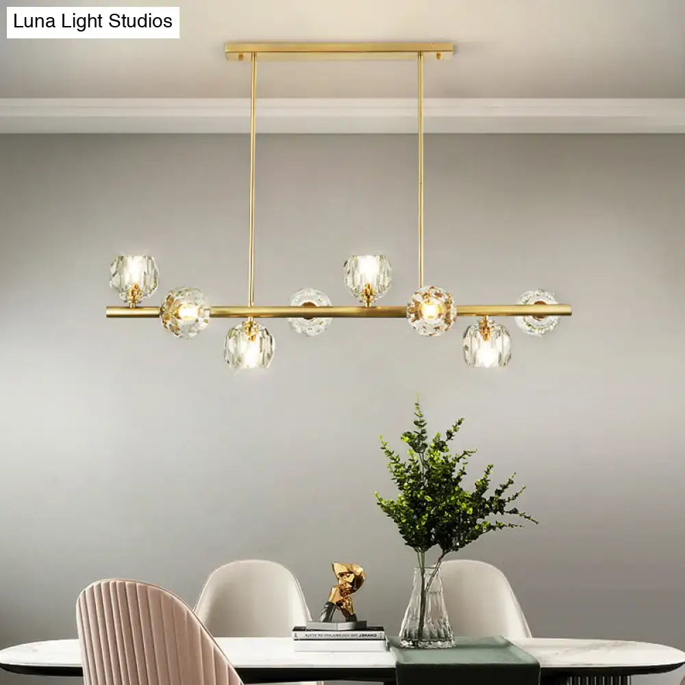 Decorbites modern gold pendant light with clear crystal globe shades suspended from a sleek horizontal bar ideal for kitchens