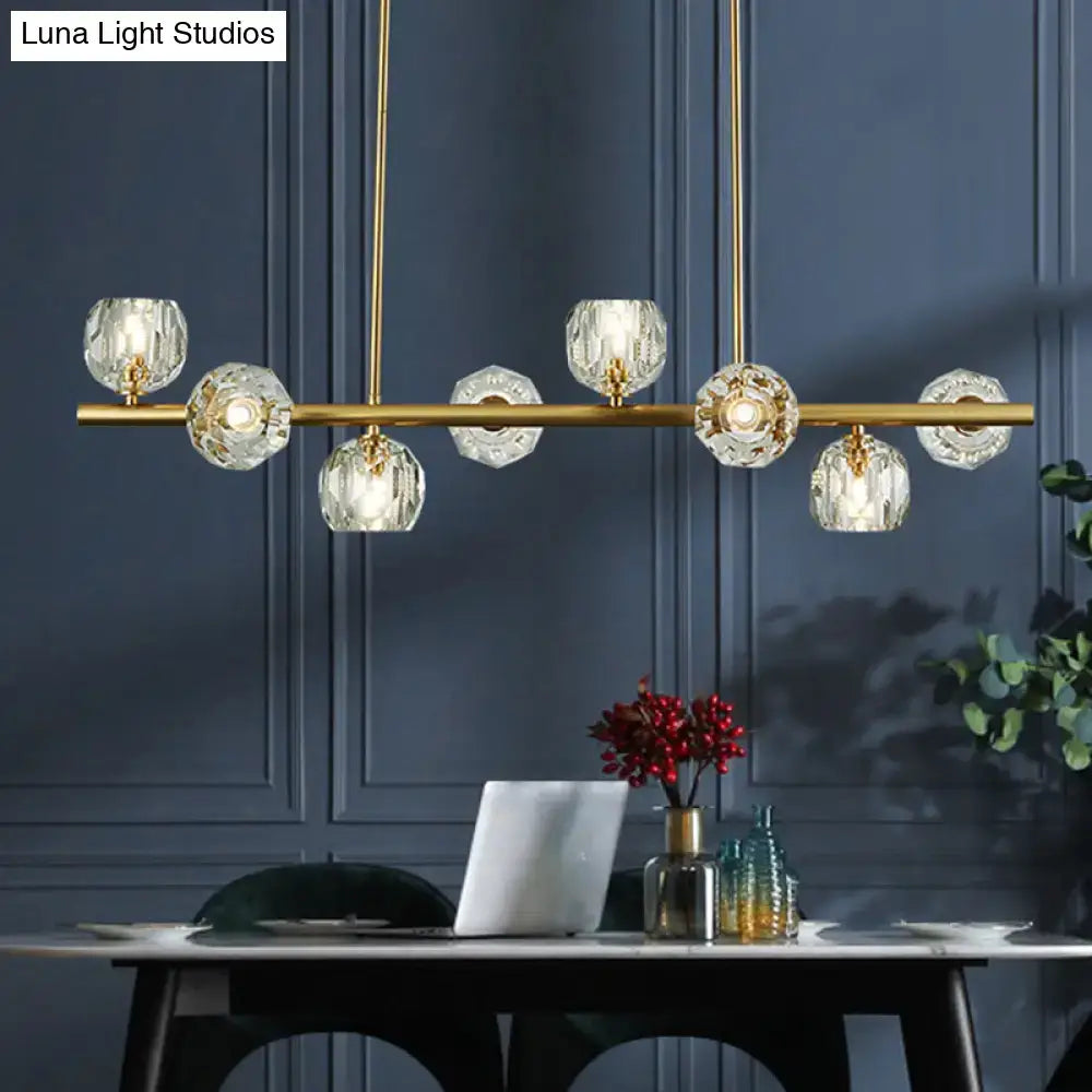 Gold pendant light by DecorBites with faceted crystal globe shades ideal for restaurants or kitchen islands