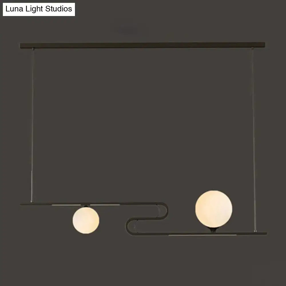 Modern black metal hanging chandelier with two frosted glass globe bulbs by DecorBites simplicity modo for dining hall island