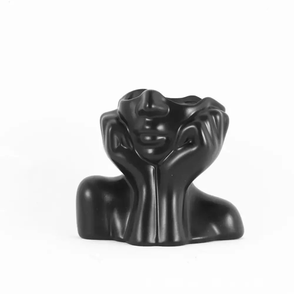 DecorBites™ modern black resin vase shaped like a human body featuring abstract woman hands framing the face design