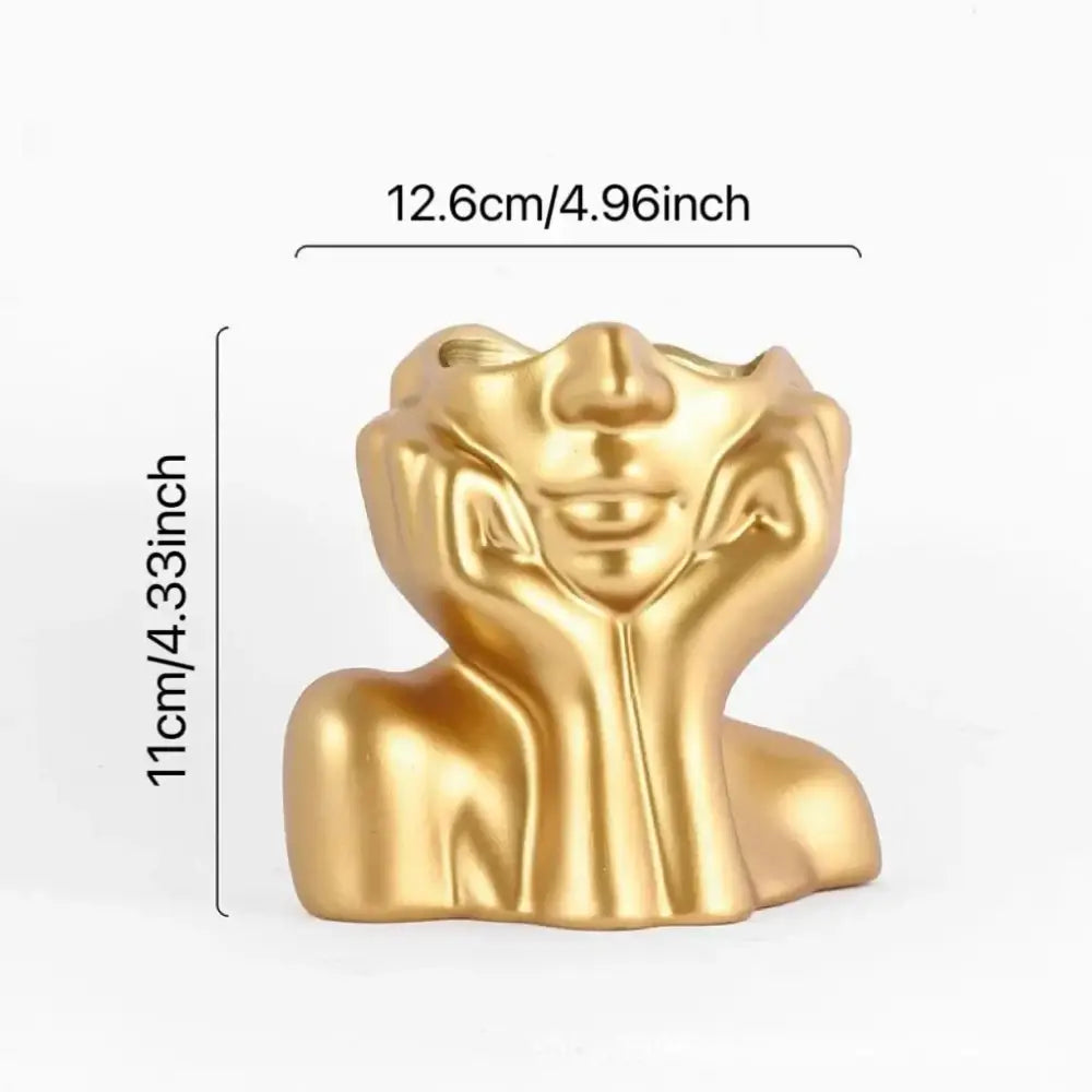 Golden metallic resin vase by decorbites shaped like a human body with hands framing the face for modern body shaping decor
