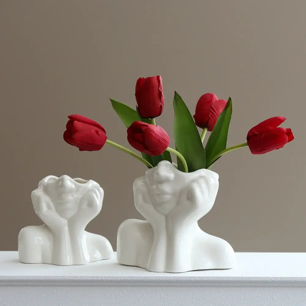 Decorbites™ modern human body shape resin vases in white ceramic with hands framing faces holding red tulips