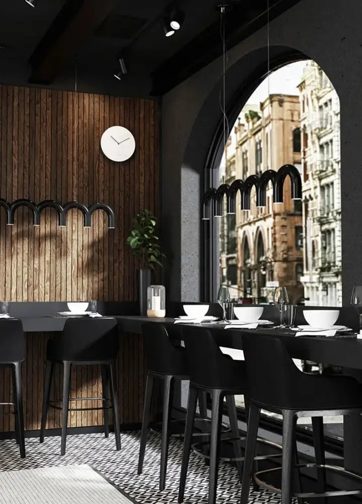 Black bar stools with sleek modern design and minimalist legs complement decorbites™ oblure arch chandelier in black