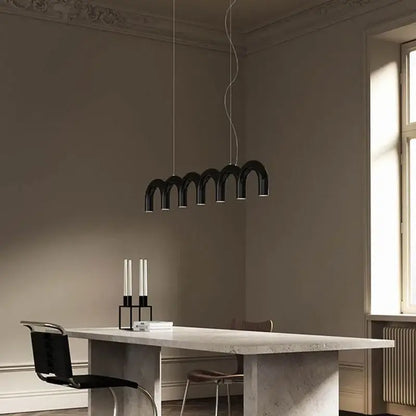 Black arch chandelier from decorbites™ modern led oblure arch chandelier with sleek design above minimalist table