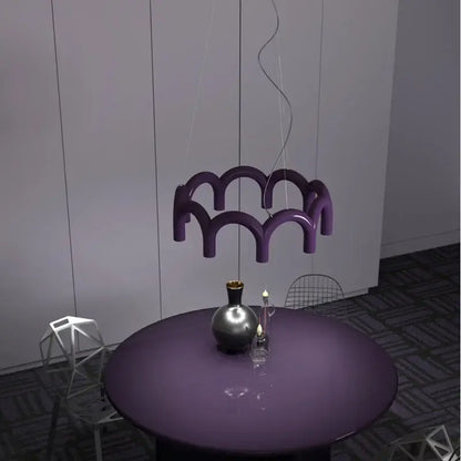Purple glossy sculptural pendant light with modern wave design from decorbites oblure arch chandelier collection