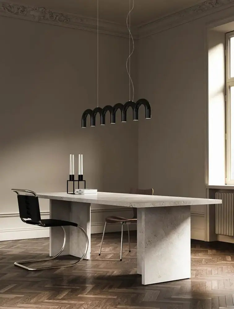 Black DecorBites™ modern led oblure arch chandelier with sleek design hanging above dining table