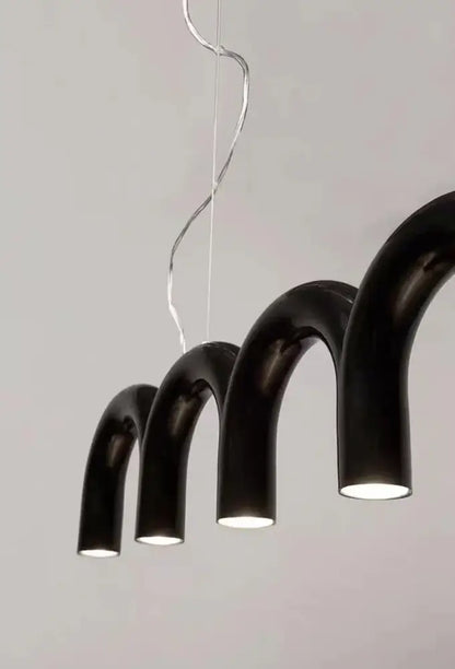 Black curved pendant light with warm glow and sleek modern design in DecorBites™ oblure arch chandelier series