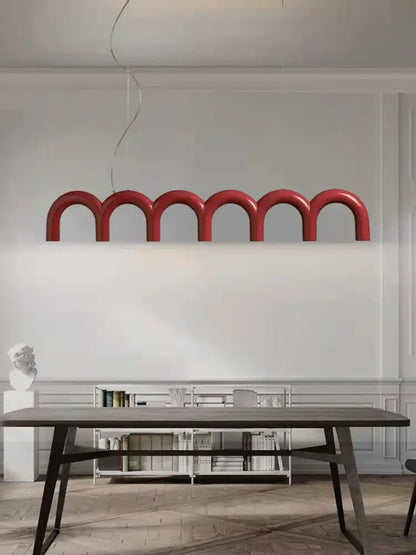 A modern red DecorBites™ arch chandelier with curved arch-shaped segments suspended from the ceiling