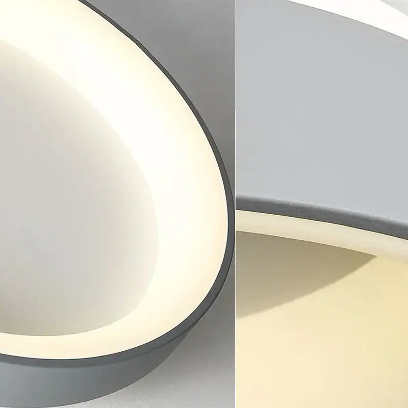 Decorbites™ modern led ceiling light with a sleek curved design, illuminated white inner surface, and matte gray rim