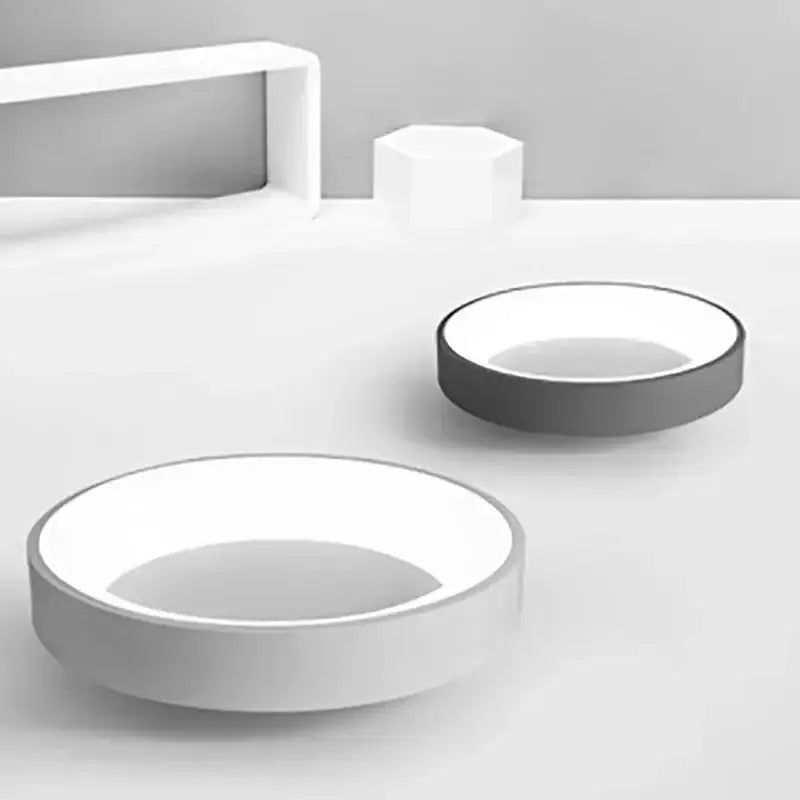 Minimalist white ceramic bowls with subtle gray rims paired with DecorBites™ modern led ceiling light for indoor use