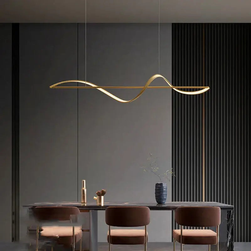 Gold-colored sleek curved pendant light with minimalist design in decorbites™ modern led chandeliers for dining