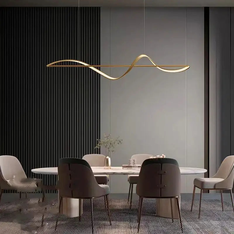 Gold-colored sleek curved linear pendant light from DecorBites™ modern led chandeliers for dining or bedroom use