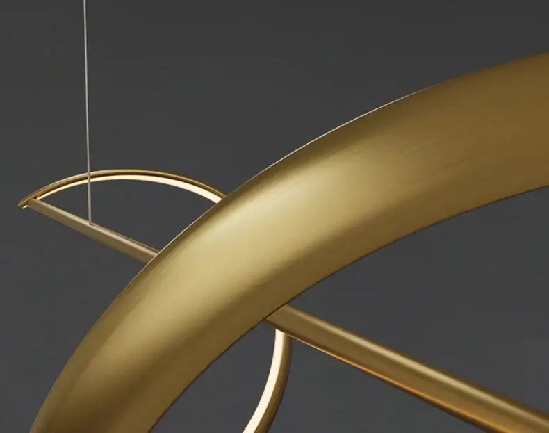 Gold-toned sleek curved metal decorbites modern led chandeliers with minimalist geometric design for dining or bedroom
