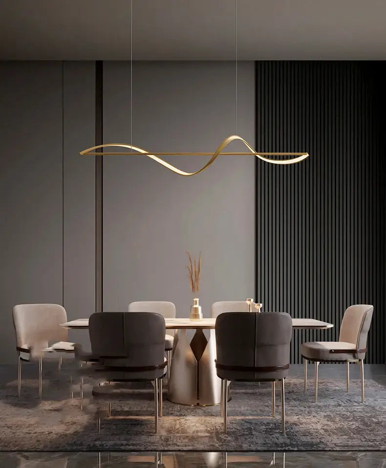 A sleek gold-toned linear pendant light with wave design from DecorBites™ modern led chandeliers for dining