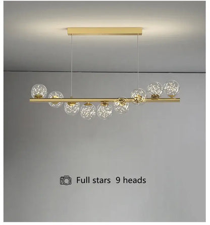 Gold-toned DecorBites™ modern led glass chandelier with nine clear glass globes on horizontal bar for dining room lighting