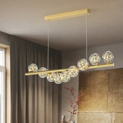 Gold-toned DecorBites™ modern led glass chandelier with clear glass spheres and warm led lights for dining room