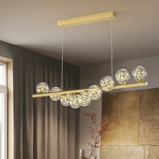 Gold-toned DecorBites™ modern led glass chandelier with clear glass spheres and warm led lights for dining room