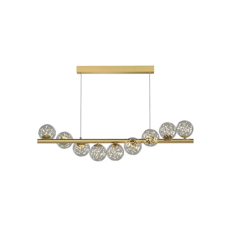 Gold-toned linear DecorBites™ modern led glass chandelier with clear speckled glass spheres for dining room lighting