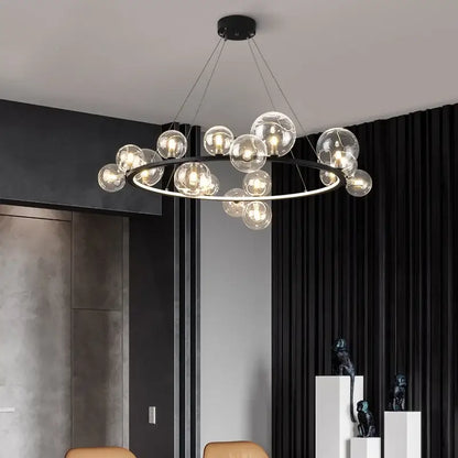 Modern black metal chandelier with clear glass bubble bulbs arranged in a circle and adjustable cord by DecorBites™