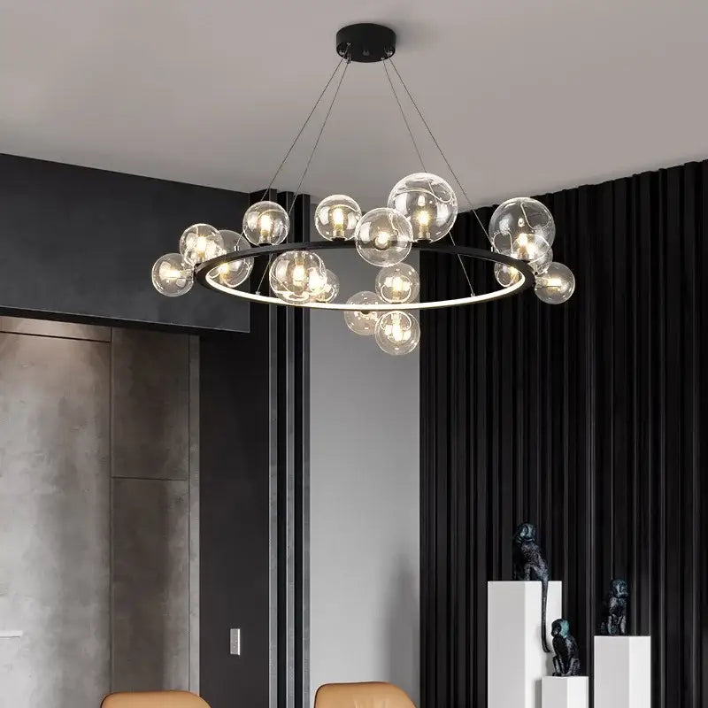 Modern black metal chandelier with clear glass bubble bulbs arranged in a circle and adjustable cord by DecorBites™