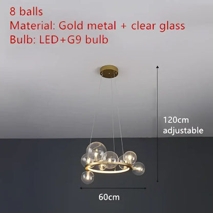 Gold metal chandelier featuring clear glass bubble spheres with LED g9 bulbs and an adjustable cord by DecorBites™