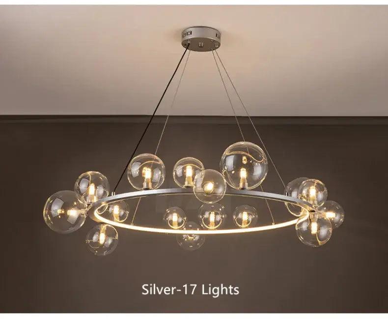 Silver DecorBites™ modern LED glass chandelier with 17 clear glass bubble bulbs and an adjustable cord in a circular design