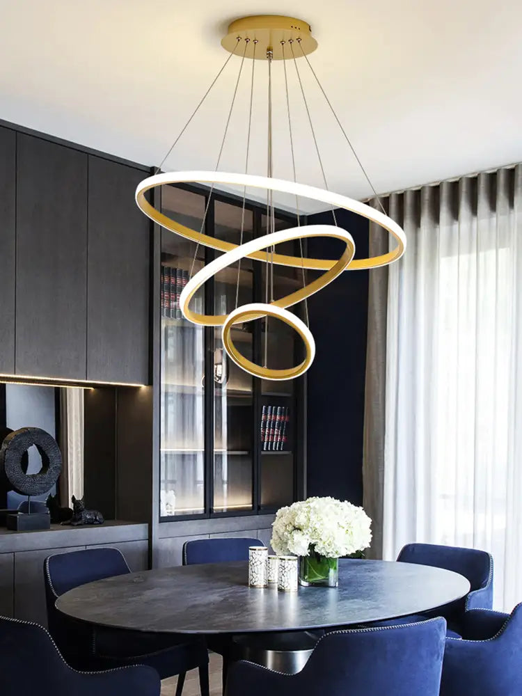 DecorBites™ modern LED pendant lamp in black with interlocking gold and white rings and brightness dimmable warm white light