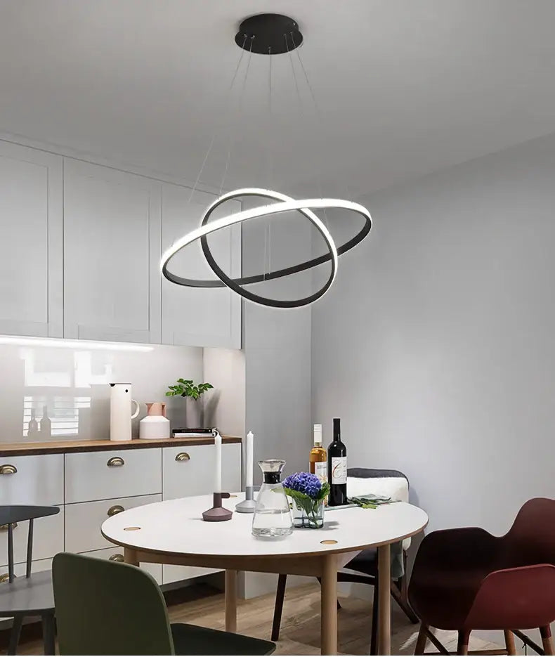 Modern black and white led ring pendant lamp with sleek intersecting circles and dimmable warm white brightness by DecorBites