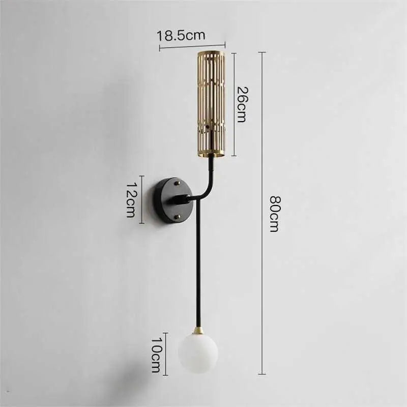 DecorBites™ modern wall sconce with black metal base, gold accents, curved arm, and frosted glass globe bulb