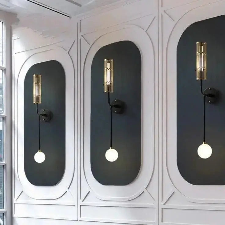 DecorBites™ modern wall sconce with gold accents features gold-toned cylindrical sconces and black articulated arms