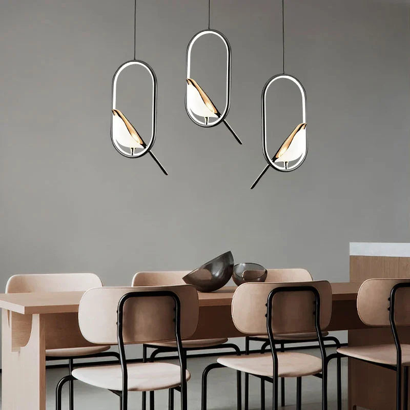 Decorbites modern magpie bird led pendant lights with sleek metallic frames and warm glass accents above dining table
