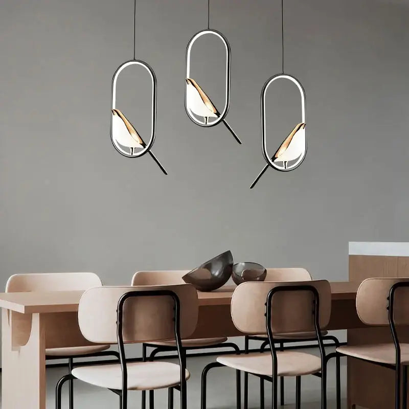 Decorbites modern magpie bird led pendant lights with sleek metallic frames and warm glass accents above dining table
