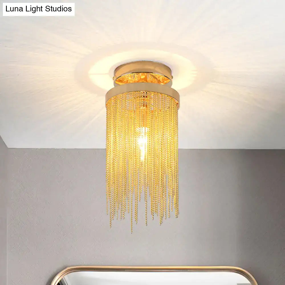 Gold-toned DecorBites™ semi flush mount lamp with cascading crystal chains and circular metallic base for living room