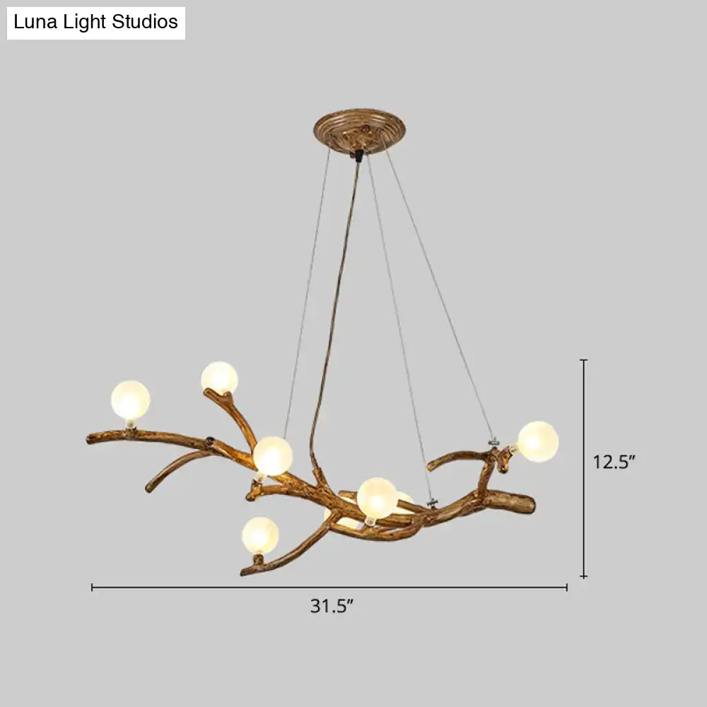 Antique brass metal tree branch chandelier with six frosted glass globes for tree branch island lighting by DecorBites