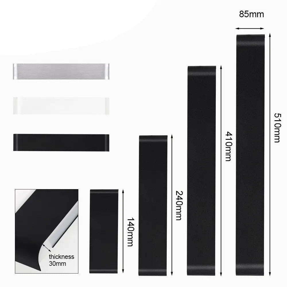 Black rubber resistance bands in various lengths and thicknesses with one 85mm wide next to modern metal wall sconces decorbites