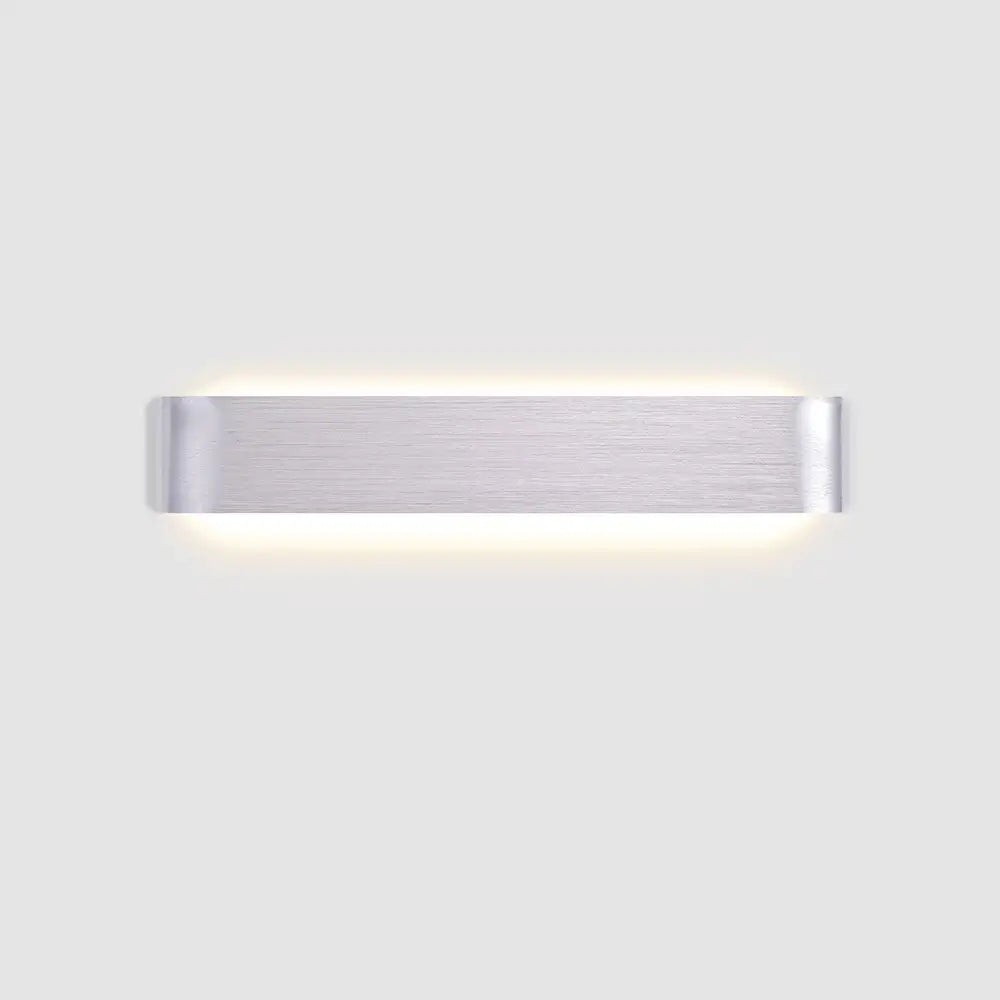 DecorBites™ modern metal wall sconce in brushed silver with sleek minimalist design and warm ambient lighting