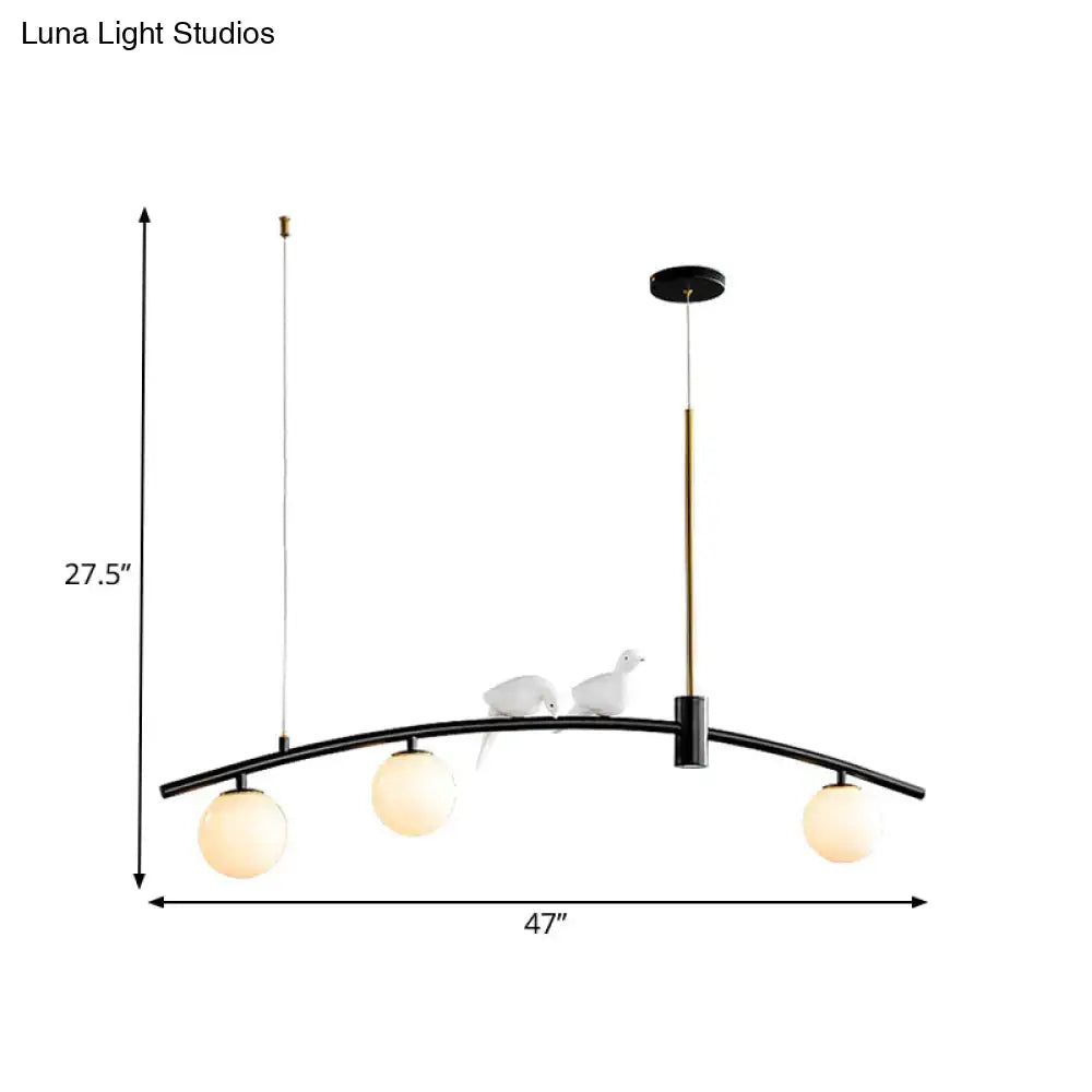 Decorbites modern mini milk glass island lamp with black arched pendant, three frosted globes, brass rod, and bird decoration