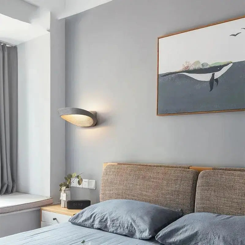 DecorBites modern minimalistic wall sconce in gray with sleek curved design and warm ambient lighting for minimalistic wall decor