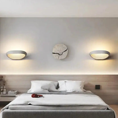 Decorbites™ modern minimalistic wall sconces in gray with ribbed oval design and warm ambient lighting for minimalistic wall decor