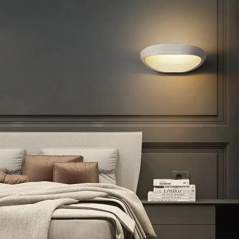 Decorbites™ modern minimalistic wall sconces with oval ribbed white ceramic finish providing warm ambient lighting