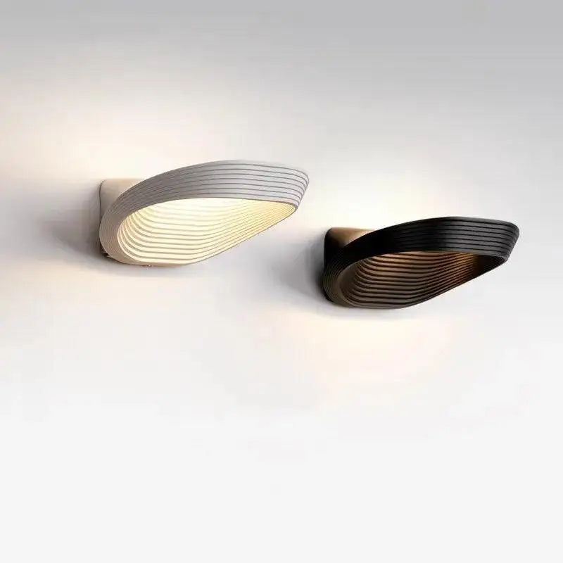 DecorBites™ modern minimalistic wall sconces with sleek curved designs, horizontal ridges, and warm glow lighting