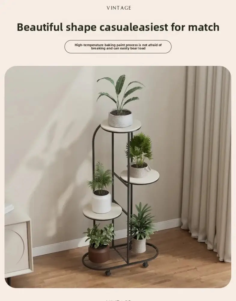 Black metal plant stand with five circular shelves holding potted green plants in ceramic pots for interior decor