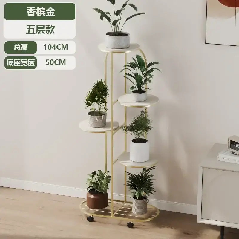 DecorBites modern five-tiered gold metal plant stand with white shelves and black caster wheels for interior decor