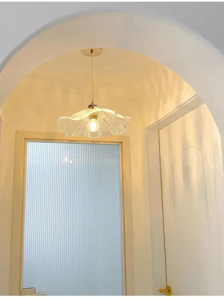 A delicate translucent glass pendant ceiling light with fluted design and brass e27 ceiling hardware for modern interiors