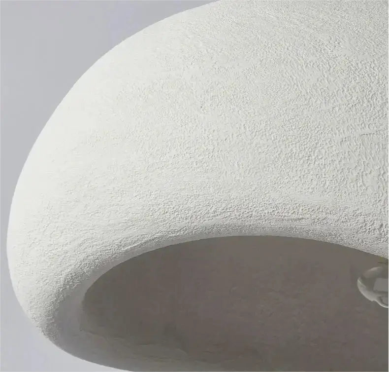 A smooth white dome-shaped decorbites modern nordic chandelier textured surface providing warm light for home and dining