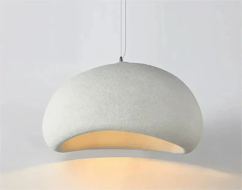 A soft off-white textured dome pendant light with warm light turn in the modern nordic chandelier DecorBites™ for dining