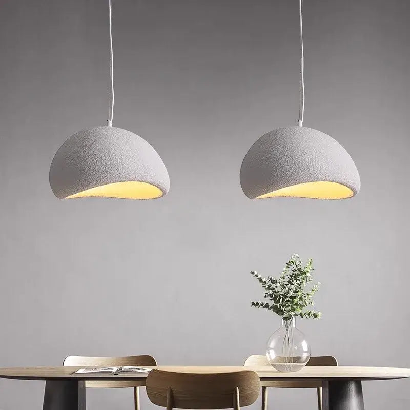 Two minimalist white pendant lights with textured dome design and warm light turn in decorbites modern nordic chandelier