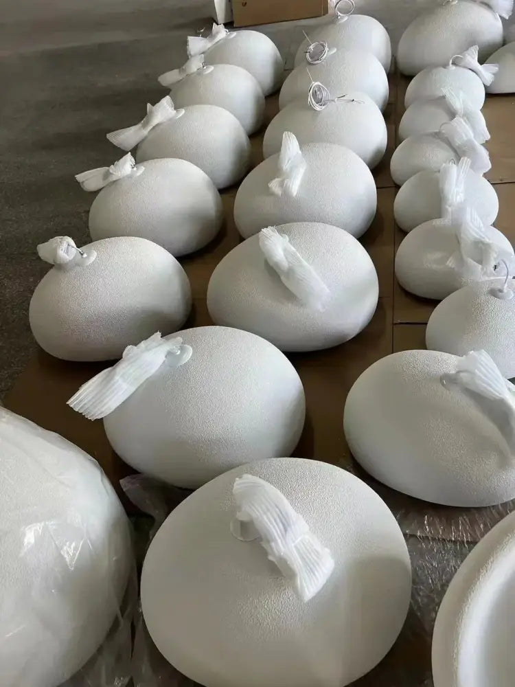 White round foam balls with textured surface and fabric ties featured in decorbites modern nordic chandelier with warm light turn