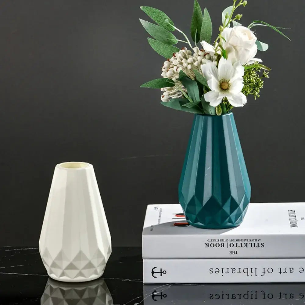 Modern nordic diamond shaped teal ceramic flower vase holding white flowers and greenery by DecorBites™