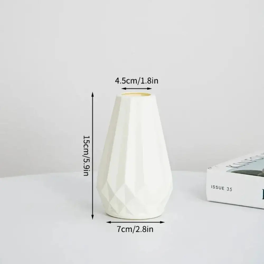 A white ceramic DecorBites™ modern nordic diamond shaped flower vase with a faceted geometric design and tapered shape